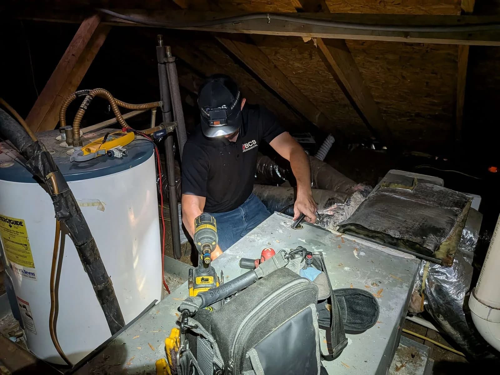 Technician working on an attic air handler
